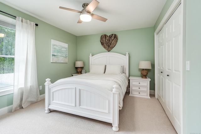 15A Shore Rd, Waterford, CT 06385 - bedroom with light carpet, a closet, multiple windows, and ceiling fan
