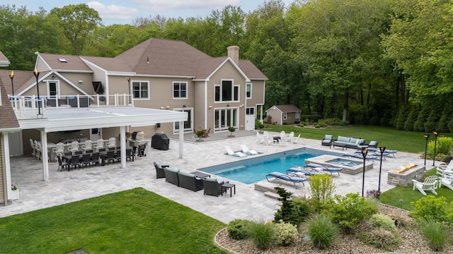 15A Shore Rd, Waterford, CT 06385 - swimming pool featuring an outdoor living space with a fire pit, a yard, a patio, outdoor dining area, and an outdoor structure