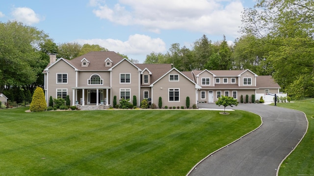 15A Shore Rd, Waterford, CT 06385 - view of front facade featuring a front lawn, a chimney, and asphalt driveway