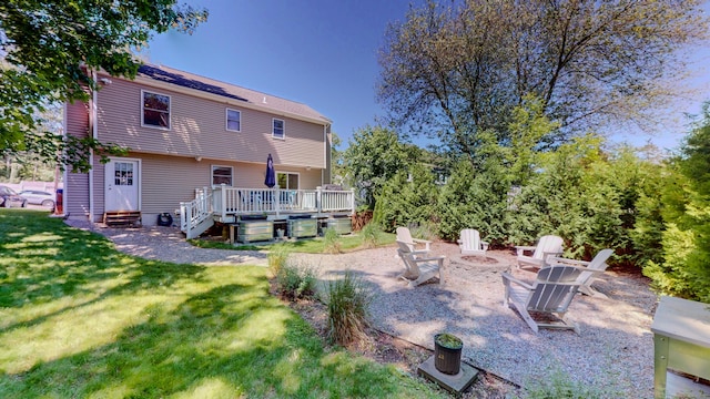 23 Bartlett Mnr, Norwalk, CT 06850 - back of property featuring a fire pit, a deck, and a lawn