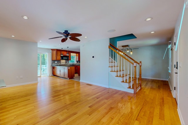 23 Bartlett Mnr, Norwalk, CT 06850 - unfurnished living room with ceiling fan, light wood-style floors, recessed lighting, stairs, and baseboards