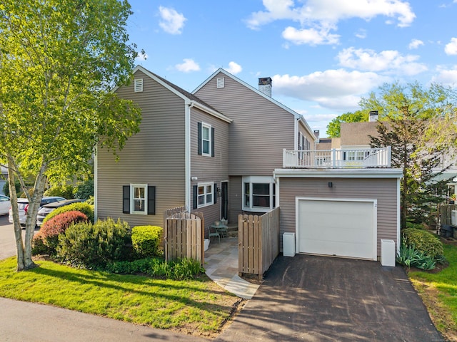 2 Quanaduck Cove Ct Unit 2, Stonington, CT 06378 - view of front facade featuring driveway, a balcony, a chimney, and a garage