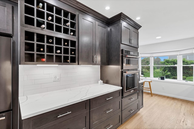 2 Quanaduck Cove Ct Unit 2, Stonington, CT 06378 - kitchen featuring light wood-style flooring, tasteful backsplash, stainless steel appliances, light stone counters, and baseboards