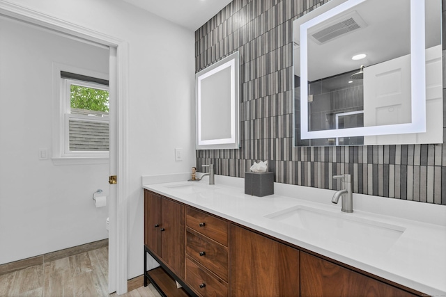 2 Quanaduck Cove Ct Unit 2, Stonington, CT 06378 - bathroom with double vanity, a shower, recessed lighting, tile walls, and baseboards