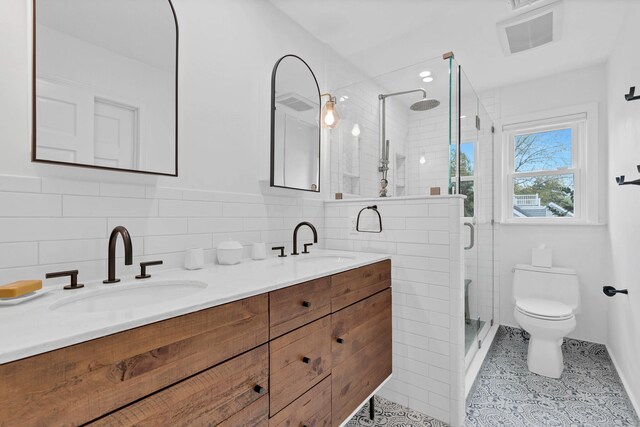 2 Quanaduck Cove Ct Unit 2, Stonington, CT 06378 - full bath featuring toilet, double vanity, a shower stall, and tile walls