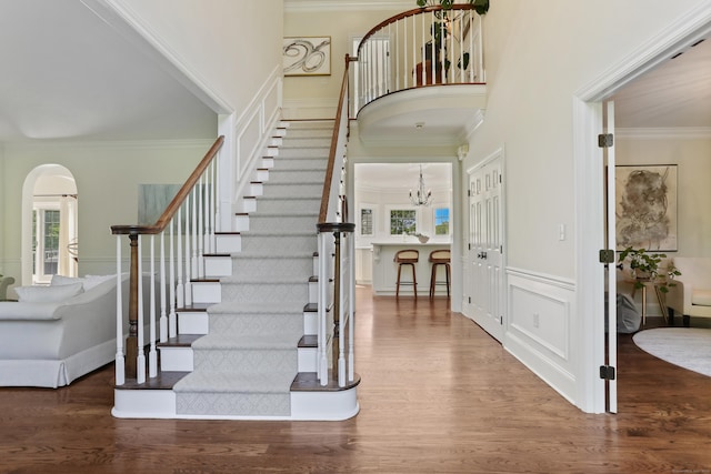10 Easton Heights Ln, Easton, CT 06612 - entrance foyer with ornamental molding, a decorative wall, stairs, arched walkways, and a chandelier