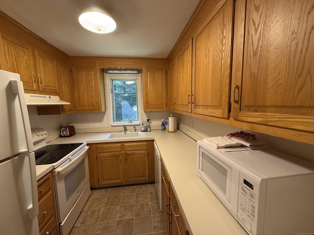 11 Gibbs St Apt 9, Winchester, CT 06098 - kitchen featuring white appliances, a sink, under cabinet range hood, light countertops, and brown cabinetry