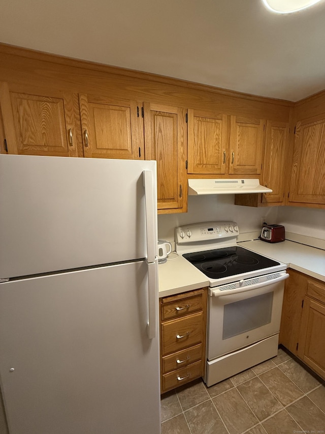 11 Gibbs St Apt 9, Winchester, CT 06098 - kitchen featuring white appliances, under cabinet range hood, light countertops, and brown cabinets
