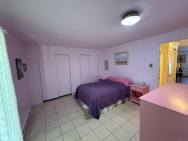 11 Gibbs St Apt 9, Winchester, CT 06098 - bedroom featuring two closets, light tile patterned floors, and a baseboard radiator