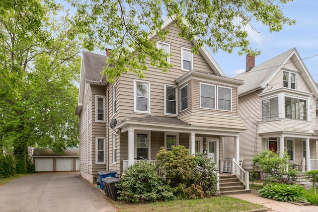76 Edwards St, New Haven, CT 06511 - view of front of home with an outbuilding, a detached garage, a porch, and a chimney