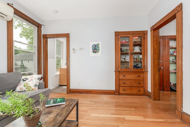 76 Edwards St, New Haven, CT 06511 - living room with a wall mounted AC, light wood-type flooring, plenty of natural light, and baseboards