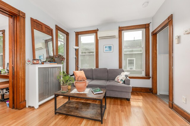 76 Edwards St, New Haven, CT 06511 - living area with a wall mounted AC, light wood-style flooring, and baseboards