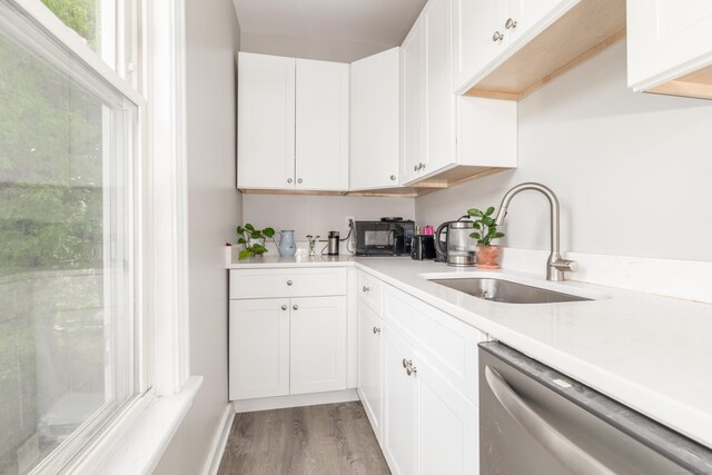 76 Edwards St, New Haven, CT 06511 - kitchen with dishwasher, a sink, wood finished floors, light countertops, and white cabinetry