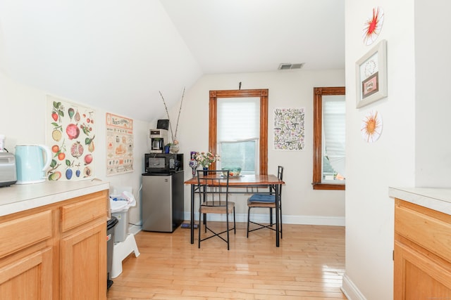76 Edwards St, New Haven, CT 06511 - kitchen featuring black microwave, vaulted ceiling, light wood-style floors, light countertops, and baseboards