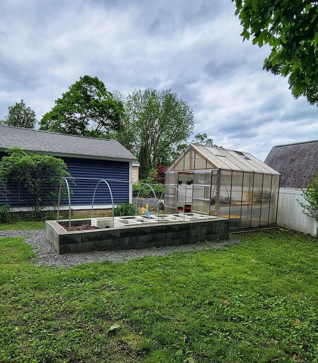 909 N Colony Rd, Meriden, CT 06450 - view of yard featuring a greenhouse, a vegetable garden, and an outbuilding