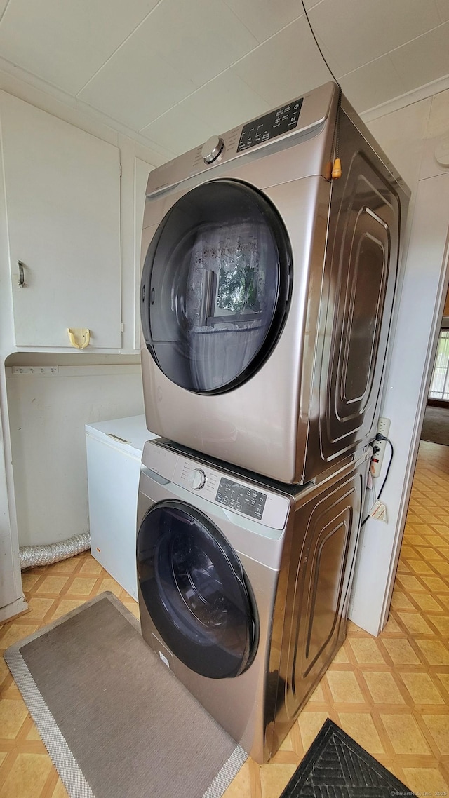 909 N Colony Rd, Meriden, CT 06450 - washroom with estacked washer and dryer and light flooring
