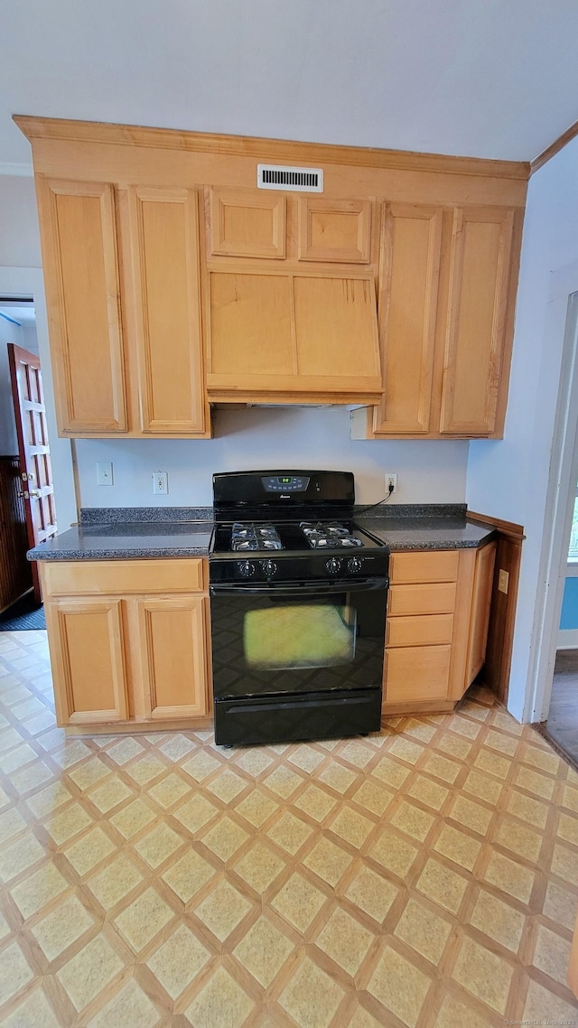 909 N Colony Rd, Meriden, CT 06450 - kitchen with gas stove, light brown cabinetry, dark countertops, and light flooring