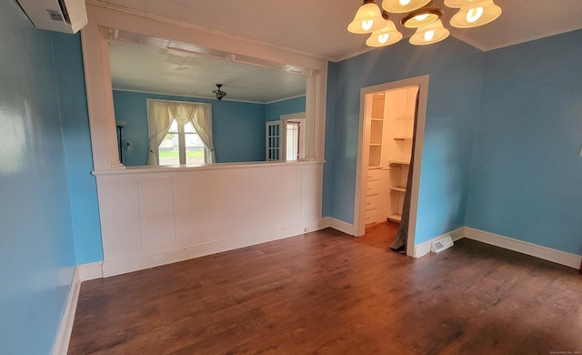 909 N Colony Rd, Meriden, CT 06450 - spare room featuring a chandelier, crown molding, dark wood-style flooring, baseboards, and a wall mounted air conditioner