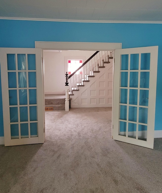 909 N Colony Rd, Meriden, CT 06450 - unfurnished living room featuring carpet flooring, crown molding, and stairs