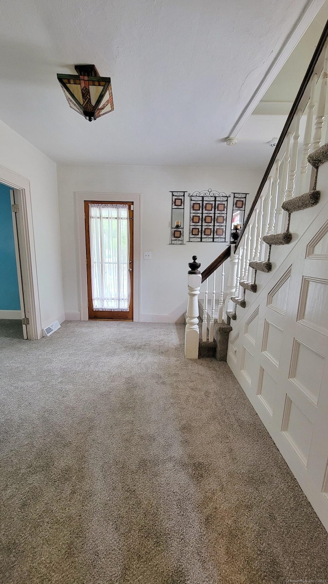909 N Colony Rd, Meriden, CT 06450 - carpeted foyer featuring stairway and baseboards