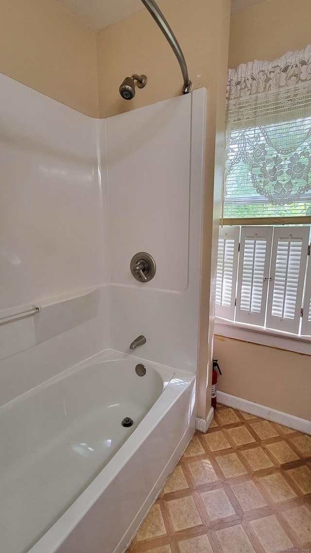 909 N Colony Rd, Meriden, CT 06450 - bathroom featuring baseboards and shower / bath combination