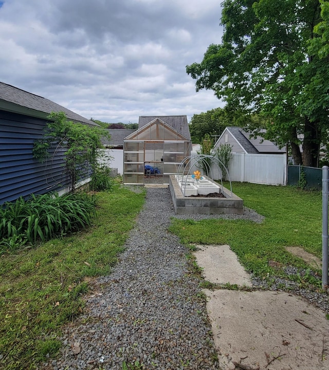 909 N Colony Rd, Meriden, CT 06450 - view of yard featuring an exterior structure, an outbuilding, and a garden
