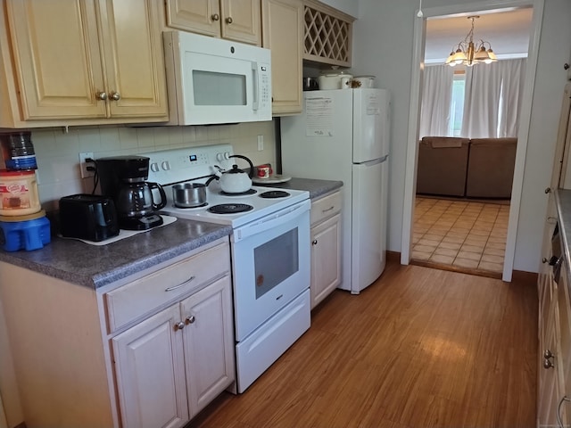 60 Engine House Rd Unit D, Stratford, CT 06614 - kitchen featuring white appliances, dark countertops, decorative backsplash, and light wood-style floors