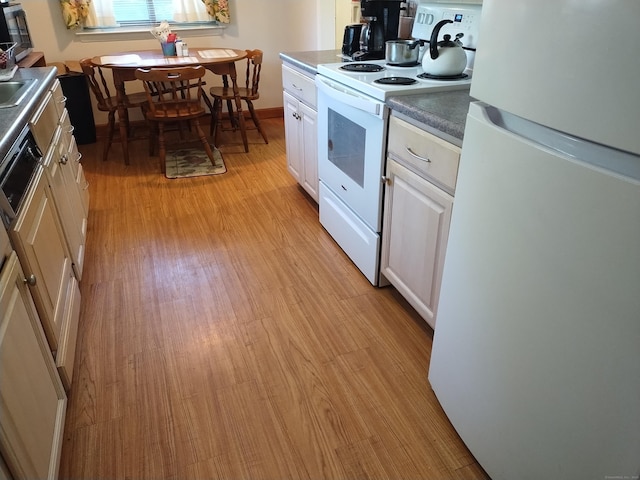 60 Engine House Rd Unit D, Stratford, CT 06614 - kitchen featuring white appliances, white cabinets, and light wood-type flooring
