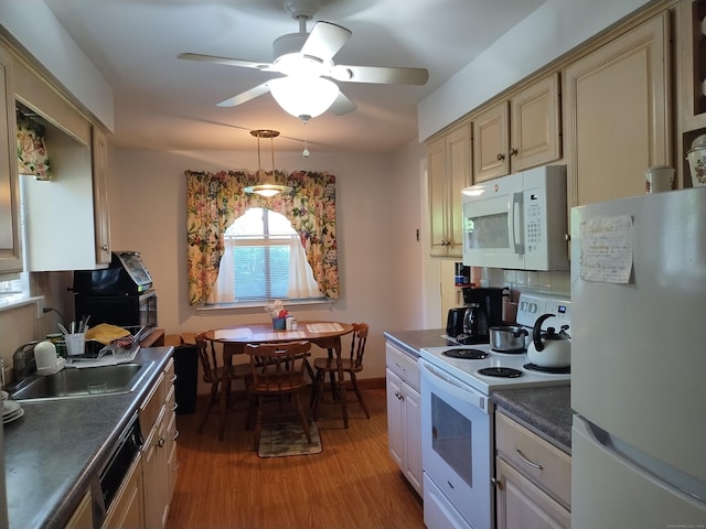 60 Engine House Rd Unit D, Stratford, CT 06614 - kitchen with white appliances, dark countertops, light wood-style flooring, cream cabinetry, and backsplash