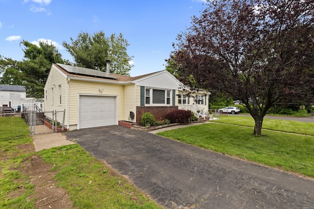 116 Crest Ave, East Haven, CT 06513 - ranch-style home featuring a garage, roof mounted solar panels, asphalt driveway, a gate, and brick siding