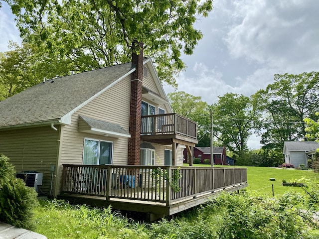 52 Lake View Ave, Salem, CT 06420 - view of property exterior featuring cooling unit, roof with shingles, a wooden deck, a chimney, and a yard