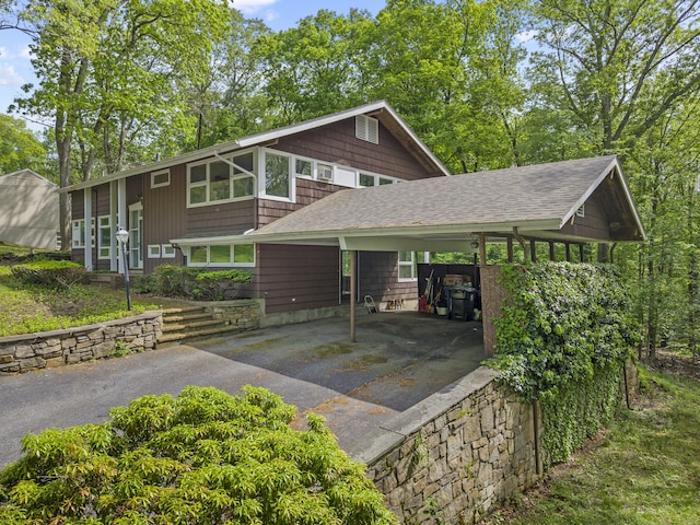 1 Indian Spring Ln, Norwich, CT 06360 - view of front of house featuring asphalt driveway, a shingled roof, and a carport