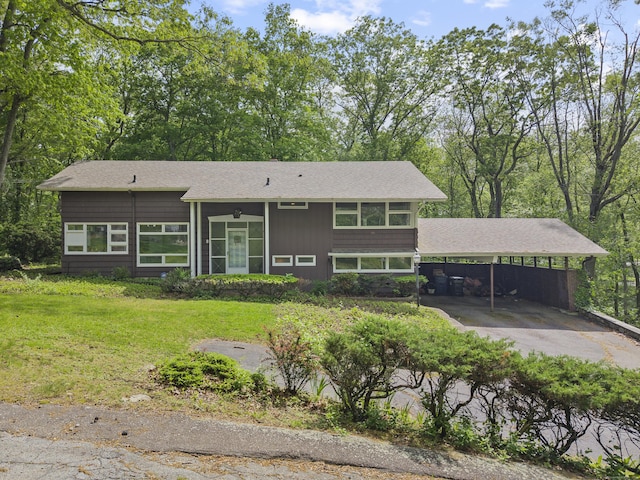 1 Indian Spring Ln, Norwich, CT 06360 - view of front of home featuring a front yard, an attached carport, and roof with shingles