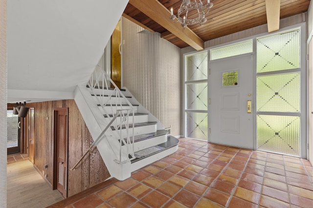 1 Indian Spring Ln, Norwich, CT 06360 - tiled entryway with wooden walls, stairway, a chandelier, and wood ceiling with exposed beams