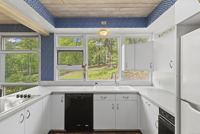 1 Indian Spring Ln, Norwich, CT 06360 - kitchen with black appliances, a sink, wallpapered walls, light countertops, and white cabinetry