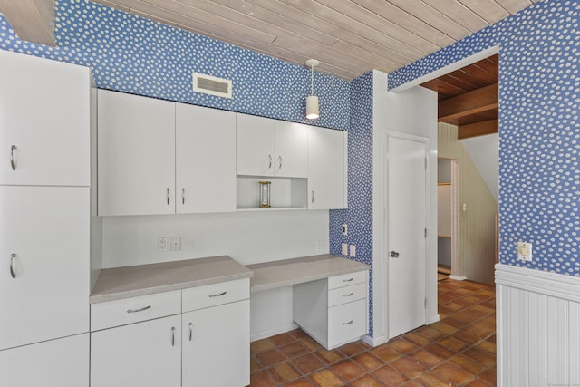1 Indian Spring Ln, Norwich, CT 06360 - kitchen with wallpapered walls, white cabinets, light countertops, and wooden ceiling
