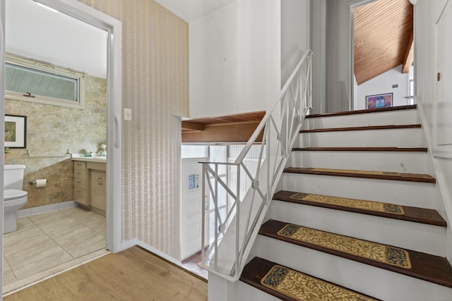 1 Indian Spring Ln, Norwich, CT 06360 - staircase featuring wallpapered walls, wood finished floors, vaulted ceiling, and wood ceiling