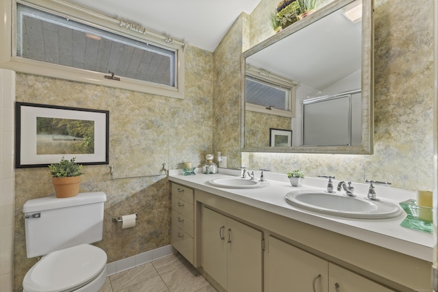 1 Indian Spring Ln, Norwich, CT 06360 - full bathroom with double vanity, vaulted ceiling, a shower with shower door, toilet, and tile patterned floors