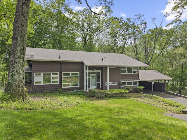 1 Indian Spring Ln, Norwich, CT 06360 - view of front of house with driveway, an attached carport, a front yard, and roof with shingles