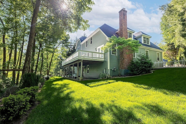 23 Mckeon Pl, Ridgefield, CT 06877 - rear view of property with a chimney and a wooden deck