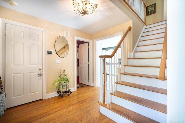 23 Mckeon Pl, Ridgefield, CT 06877 - foyer entrance with wood finished floors, stairway, and baseboards