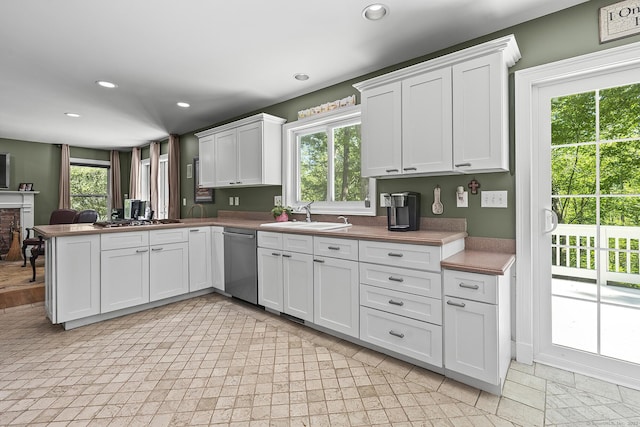 23 Mckeon Pl, Ridgefield, CT 06877 - kitchen featuring stainless steel dishwasher, a sink, plenty of natural light, white cabinetry, and recessed lighting
