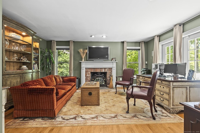 23 Mckeon Pl, Ridgefield, CT 06877 - living room featuring plenty of natural light, wood finished floors, and a brick fireplace
