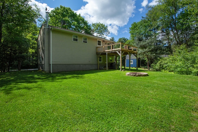 69 Fernwood Dr, Simsbury, CT 06070 - rear view of property featuring an outdoor fire pit, a wooden deck, and a yard