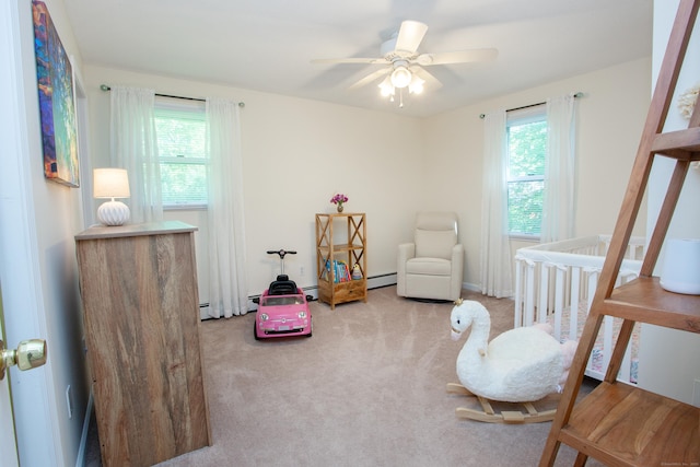 69 Fernwood Dr, Simsbury, CT 06070 - carpeted bedroom featuring a baseboard heating unit, a nursery area, and a ceiling fan