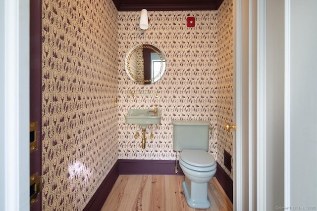 14 Main St, Salisbury, CT 06039 - half bath featuring wood finished floors, wallpapered walls, toilet, a sink, and baseboards
