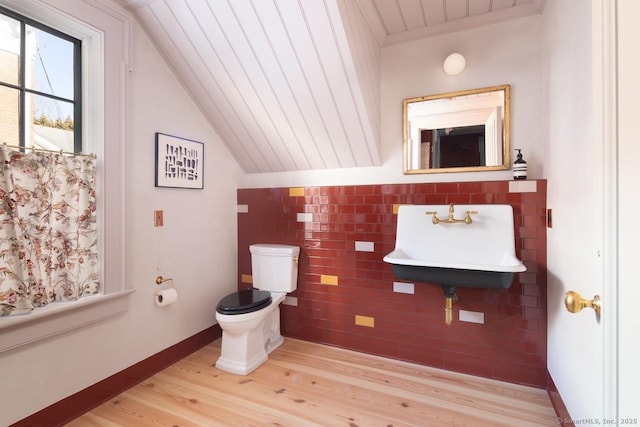 14 Main St, Salisbury, CT 06039 - half bath featuring toilet, a sink, wood finished floors, tile walls, and vaulted ceiling