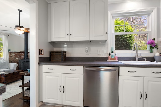 2 Latimer Ct, Waterford, CT 06385 - kitchen with stainless steel dishwasher, a sink, dark countertops, and plenty of natural light