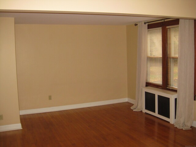 1071 River Blvd, Suffield, CT 06078 - unfurnished room with radiator heating unit, wood finished floors, and baseboards