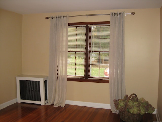 1071 River Blvd, Suffield, CT 06078 - spare room featuring dark wood-style flooring, radiator, and baseboards